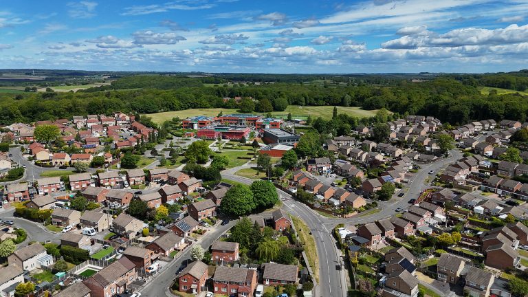 A view over the parish from a drone showing the secondary school and the landscape into the distance